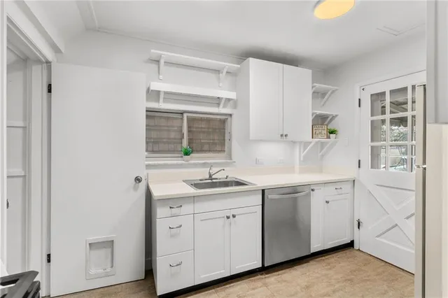 a kitchen with a sink a refrigerator and cabinets