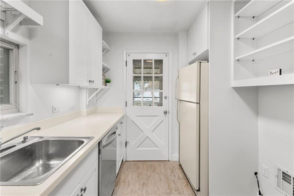4227 Lydia Street Pittsburgh, PA 15207 - Photo 18 of 44 a kitchen with a sink a refrigerator and cabinets