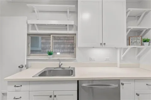 a kitchen with a sink cabinets and stainless steel appliances