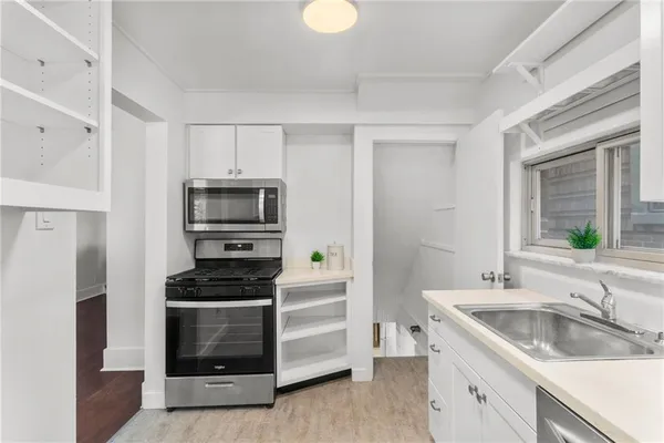 a kitchen with a stove and a microwave