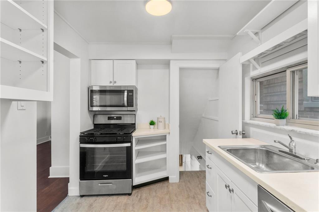 4227 Lydia Street Pittsburgh, PA 15207 - Photo 21 of 44 a kitchen with a sink cabinets and stainless steel appliances