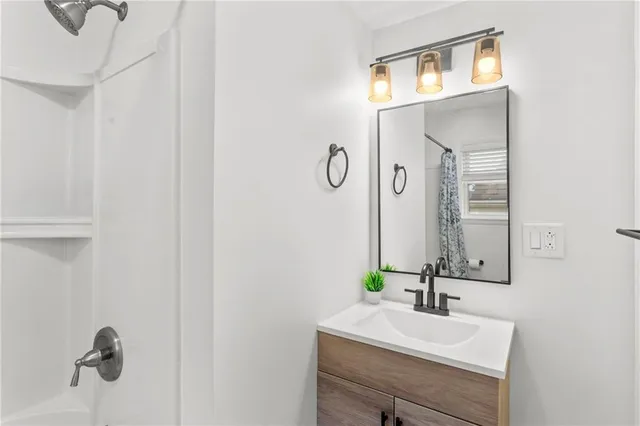 a bathroom with a shower curtain and a window