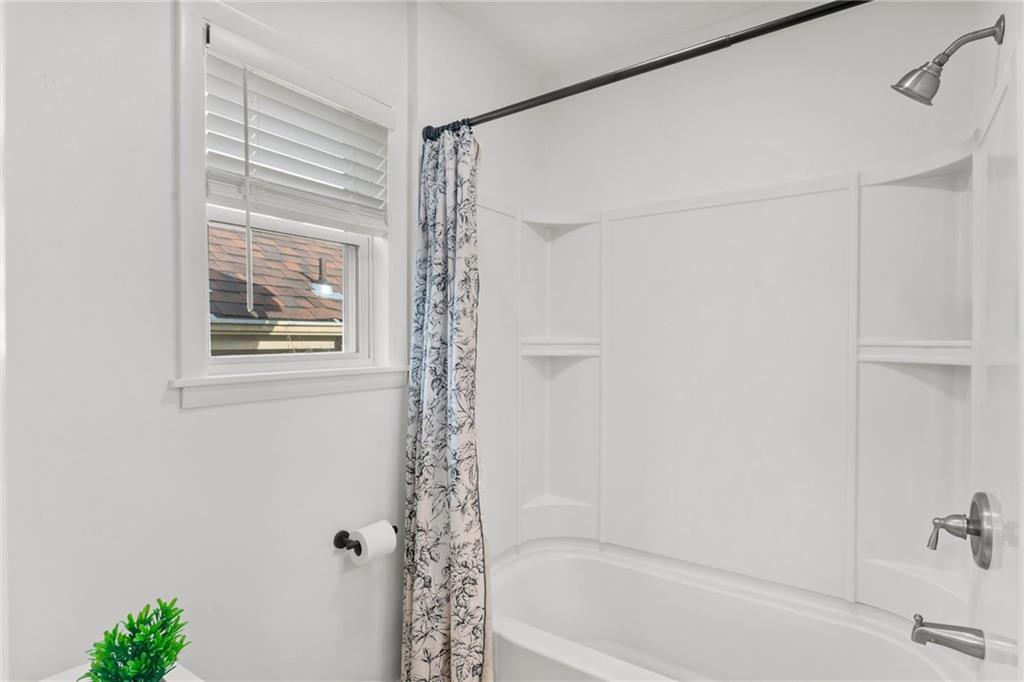 4227 Lydia Street Pittsburgh, PA 15207 - Photo 28 of 44 a bathroom with a shower curtain and a window