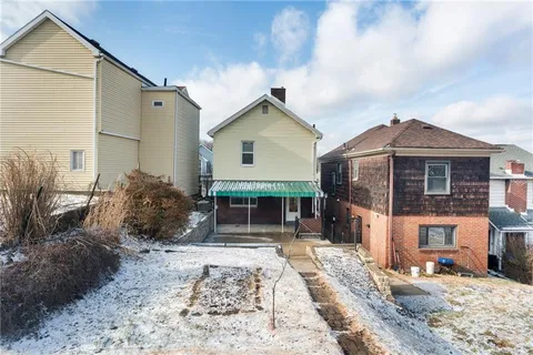 a view of a house with wooden fence