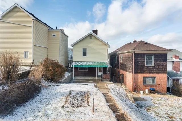 a view of a house with wooden fence
