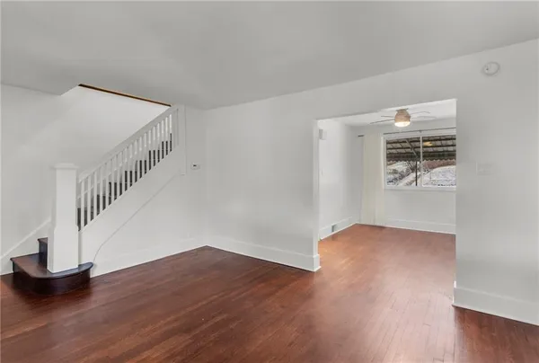 a view of entryway and hall with wooden floor