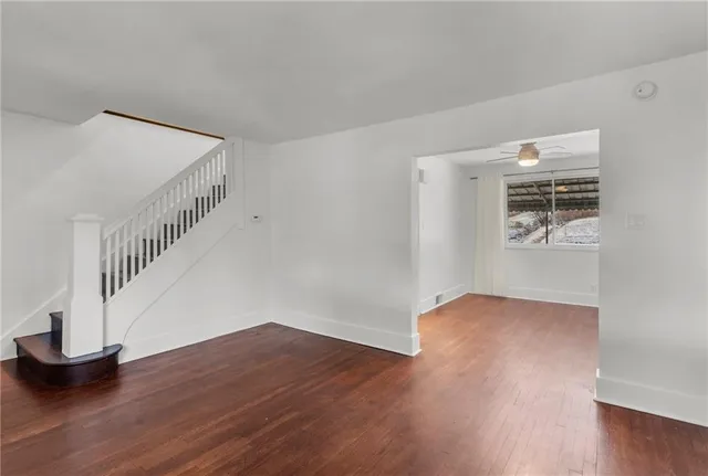 a view of entryway and hall with wooden floor