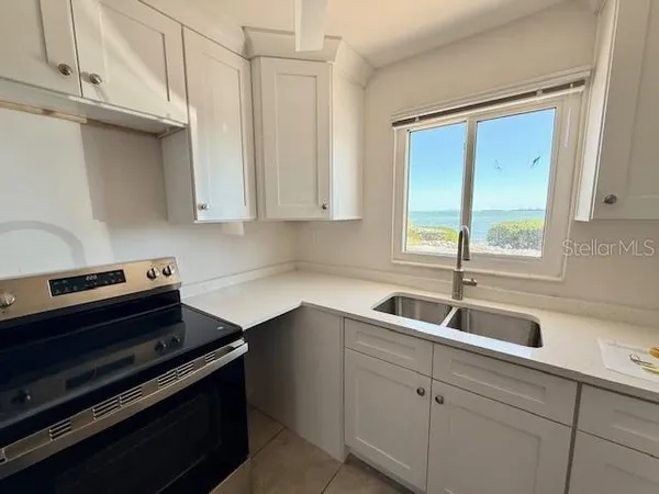 a kitchen with sink cabinets and appliances
