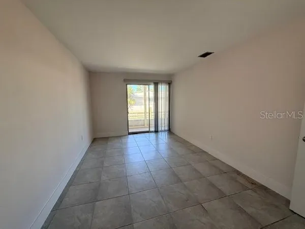 a view of an empty room with a window
