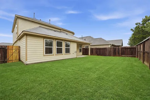 a view of a house with a backyard