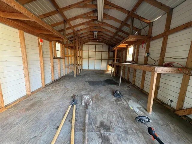 a white house that has a tree in front of it