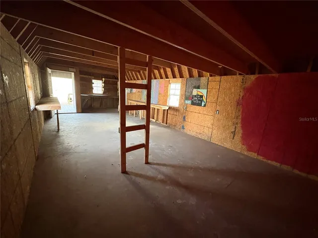 a view of empty field with wooden fence