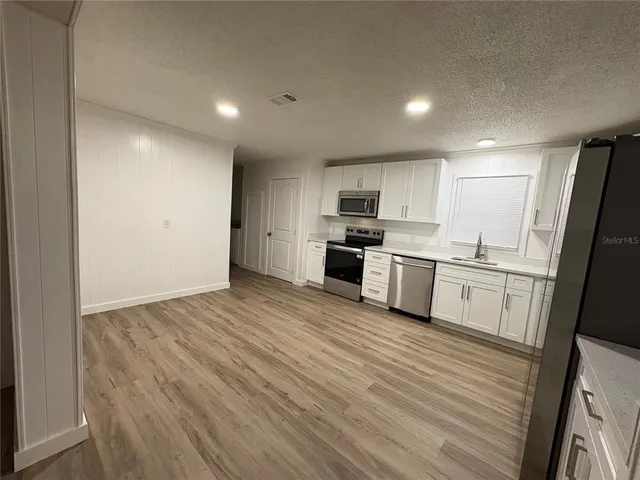 a bathroom with a sink toilet tub and shower
