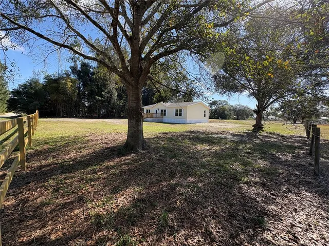 a view of deck with wooden floor and trees