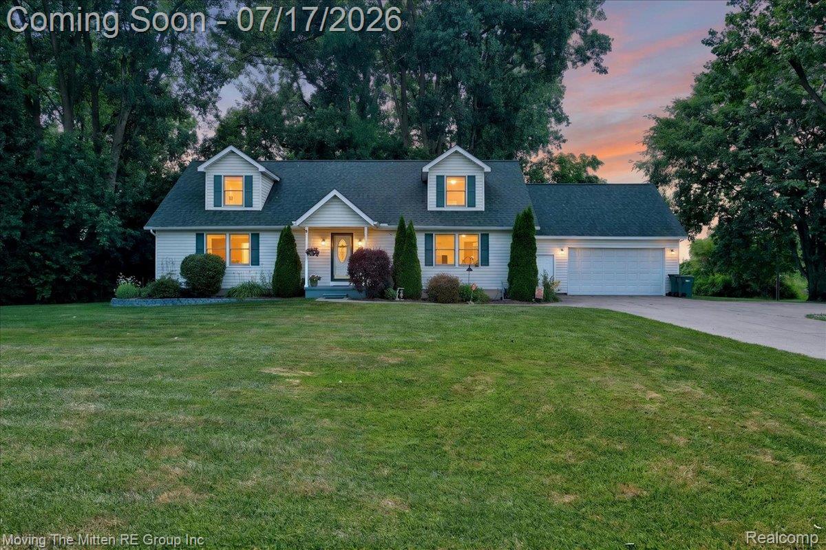 40162 Alden Road Belleville, MI 48111 - Photo 1 of 67 White siding residence featuring a dark shingle roof, attached two-car garage, and a lush green lawn
