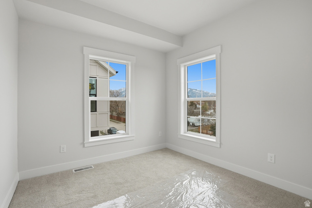 7338 South Seven Tree Lane, Unit 75 Midvale, UT 84047 - Photo 21 of 30 Spare room featuring light colored carpet and baseboards