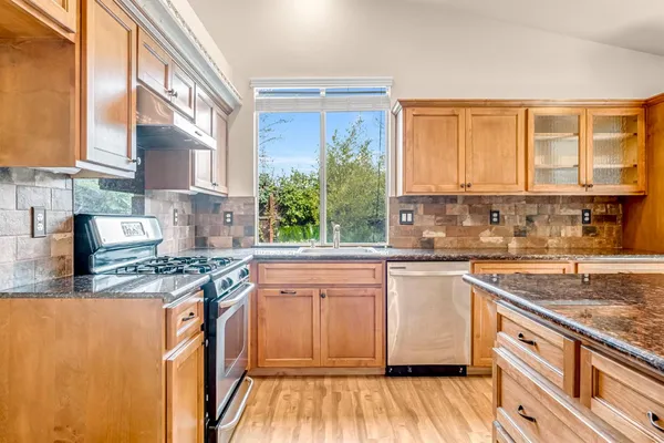 a view of room with walk in closet and wooden floor