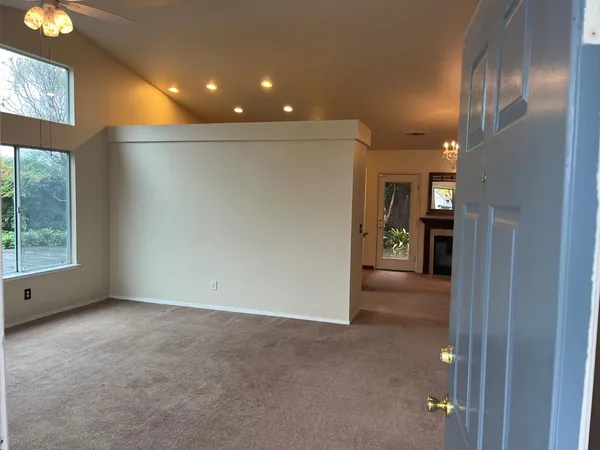 a living room with furniture a window and a table