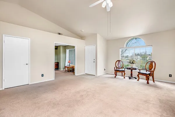 a large kitchen with a fireplace and a large window
