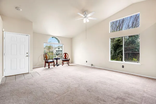 a large white kitchen with cabinets a sink and a stove