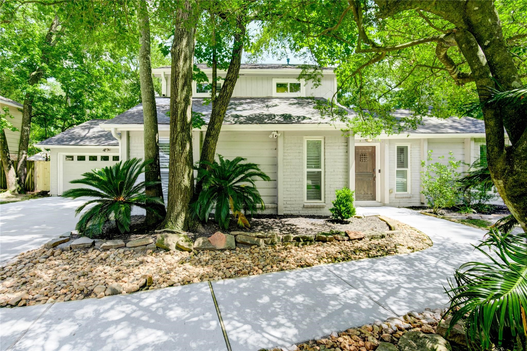 1904 Nursery Road The Woodlands, TX 77380 - Photo 1 of 43 a front view of a house with garden