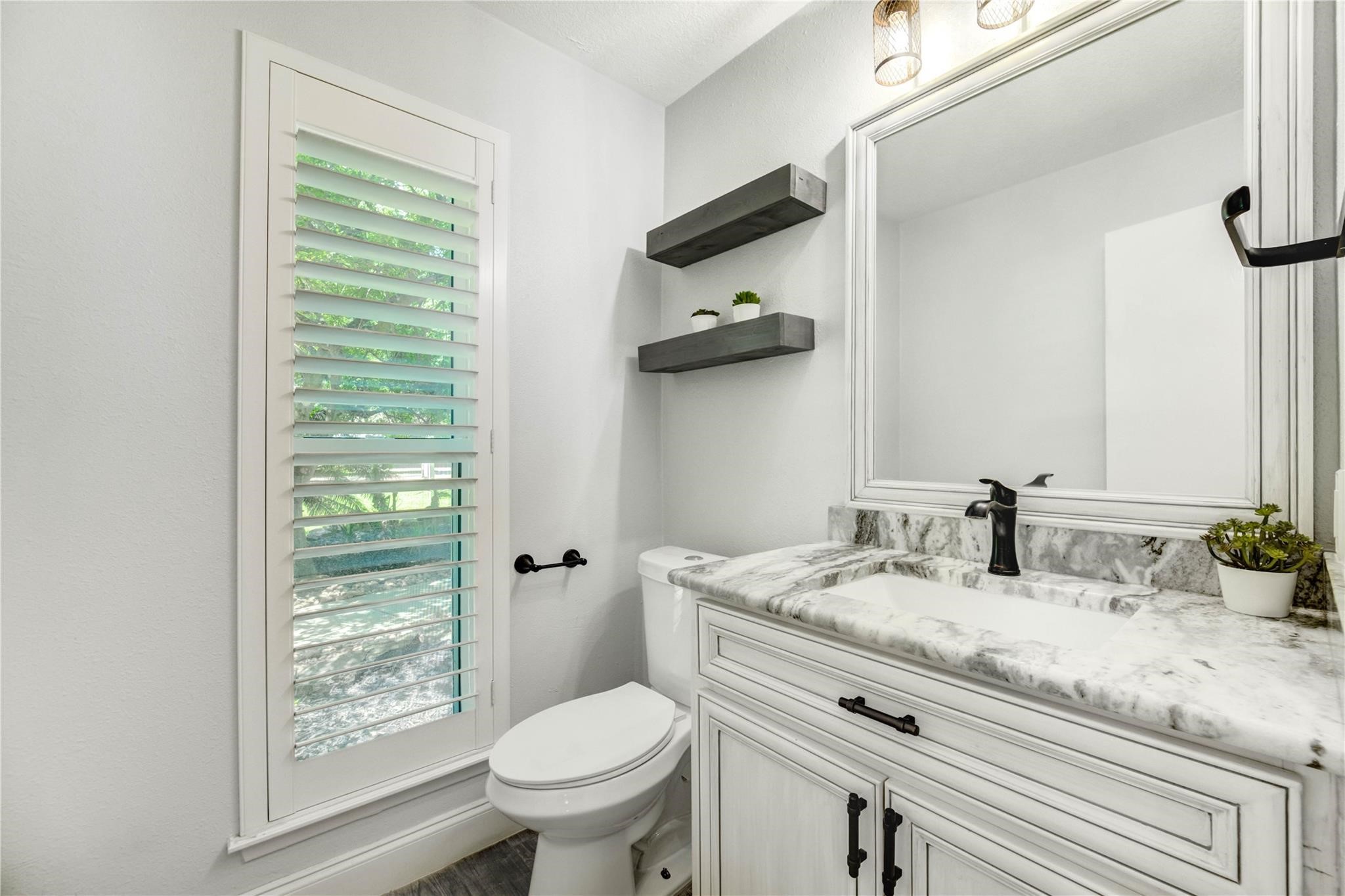 1904 Nursery Road The Woodlands, TX 77380 - Photo 16 of 43 a bathroom with a granite countertop sink toilet and shower