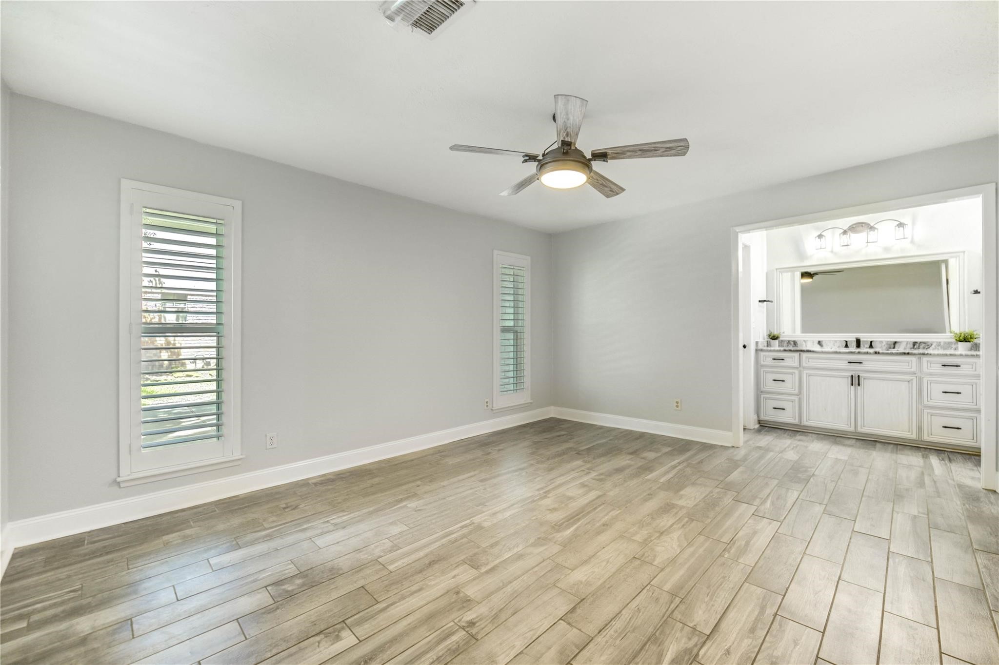 1904 Nursery Road The Woodlands, TX 77380 - Photo 19 of 43 a view of empty room with wooden floor and fan