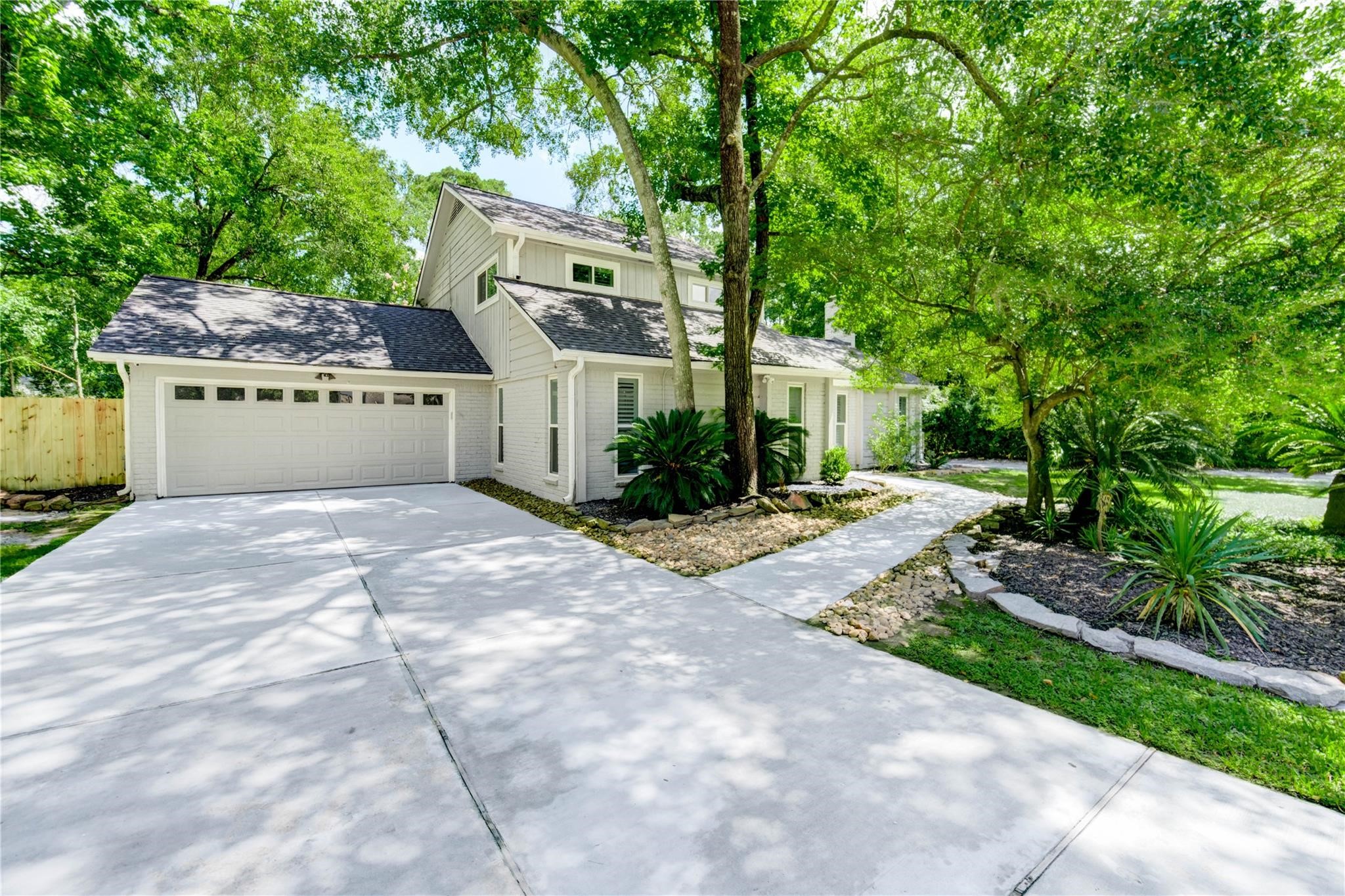 1904 Nursery Road The Woodlands, TX 77380 - Photo 2 of 43 a front view of a house with a yard and trees