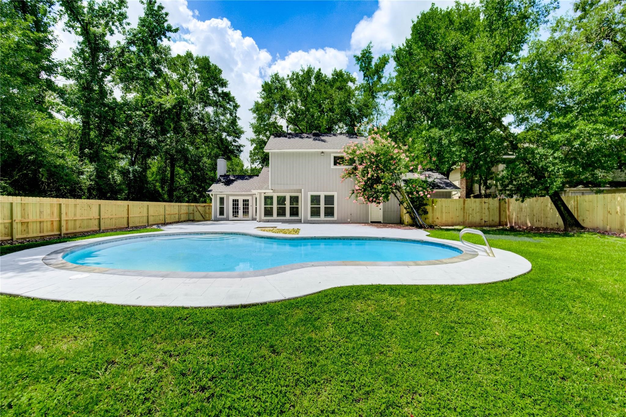 1904 Nursery Road The Woodlands, TX 77380 - Photo 35 of 43 a view of pool with a house in the background