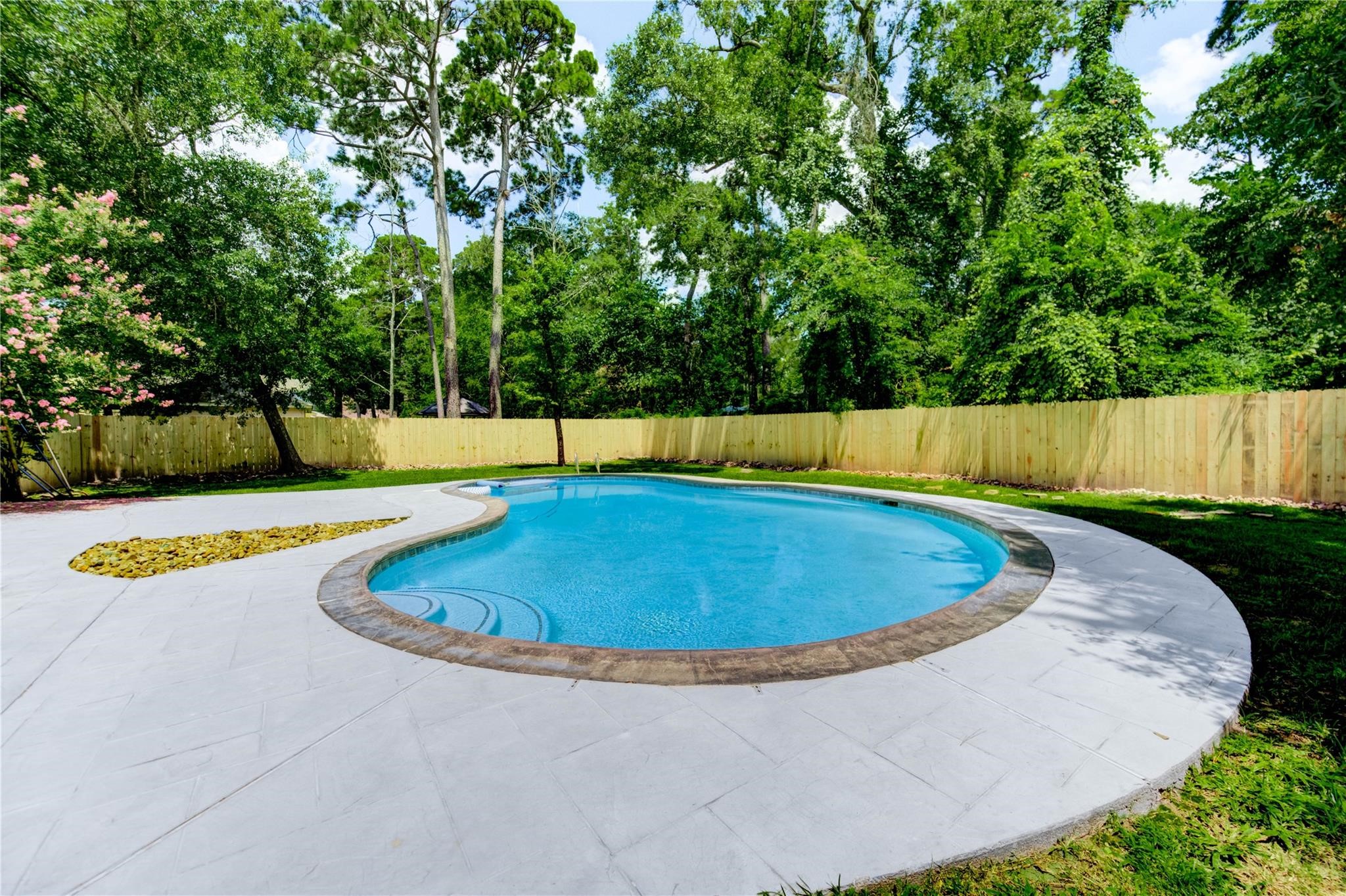 1904 Nursery Road The Woodlands, TX 77380 - Photo 39 of 43 a view of a swimming pool with a yard and trees
