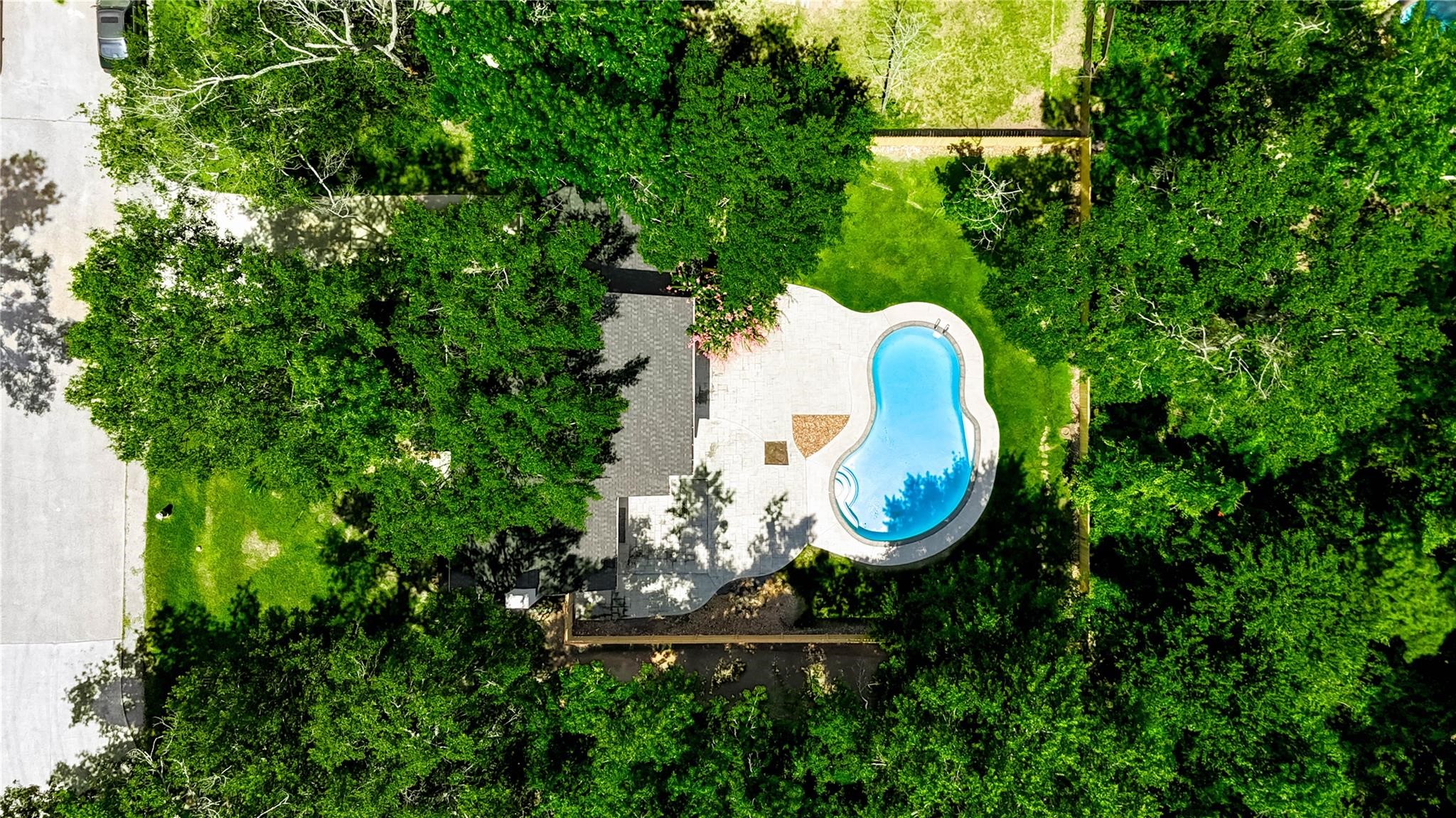 1904 Nursery Road The Woodlands, TX 77380 - Photo 40 of 43 an aerial view of a house with swimming pool and garden view