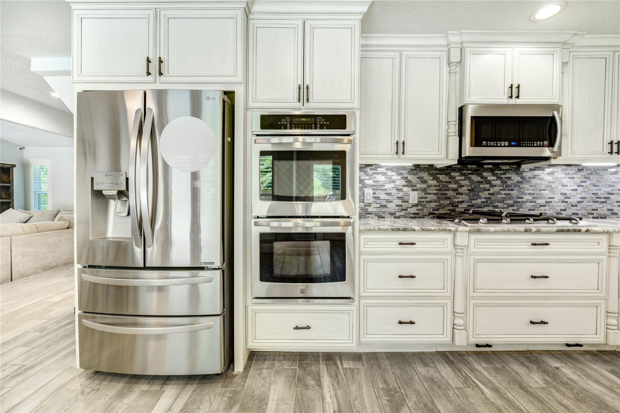 1904 Nursery Road The Woodlands, TX 77380 - Photo 9 of 43 a kitchen with granite countertop white cabinets and stainless steel appliances