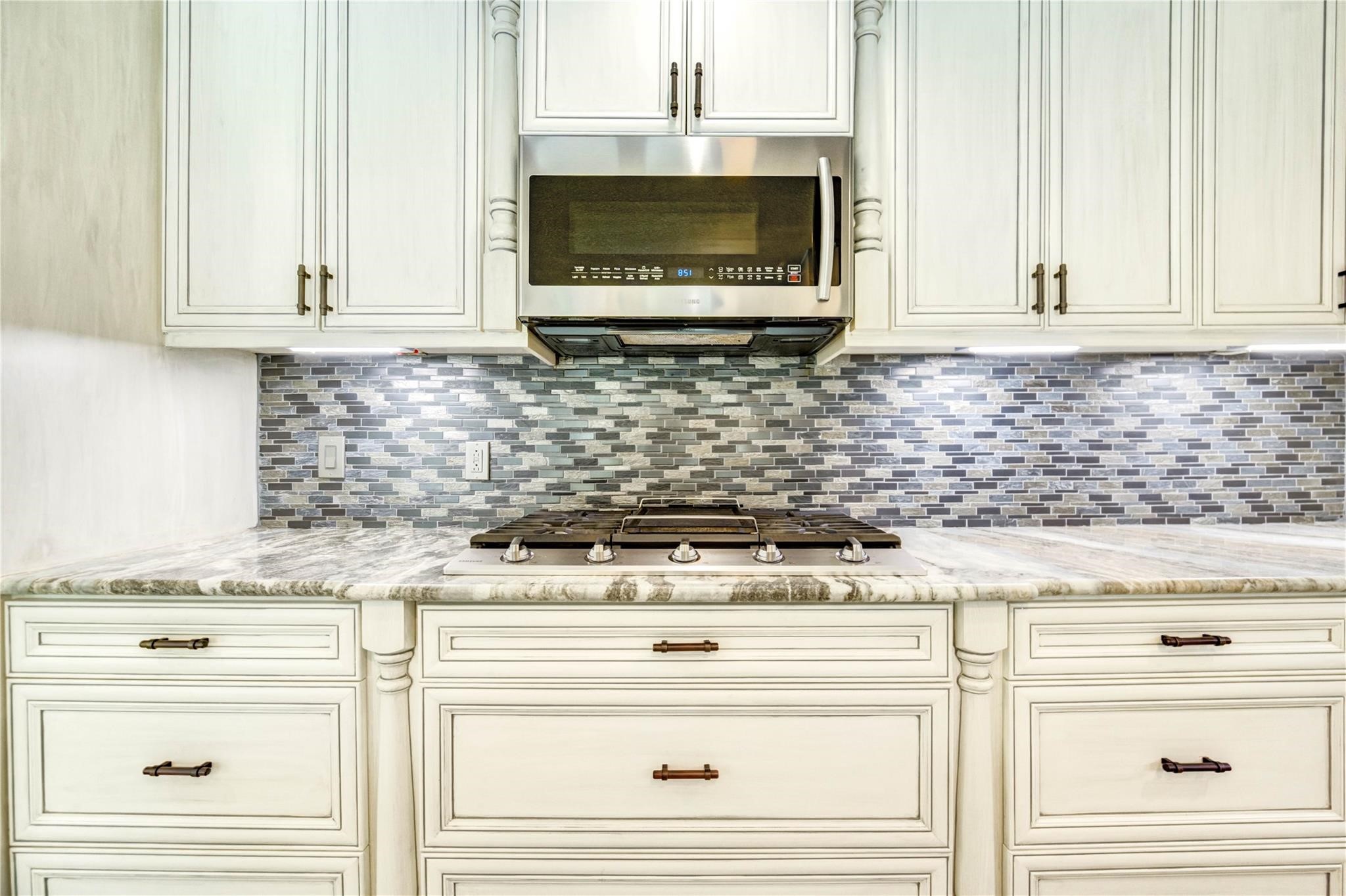 1904 Nursery Road The Woodlands, TX 77380 - Photo 10 of 43 a kitchen with granite countertop white cabinets and stainless steel appliances