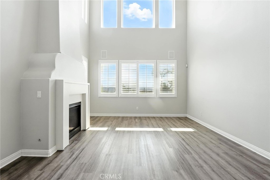 18338 Lakepointe Drive Riverside, CA 92503 - Photo 11 of 40 a view of an empty room with wooden floor and a window