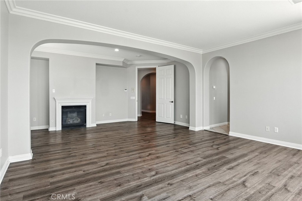 18338 Lakepointe Drive Riverside, CA 92503 - Photo 14 of 40 an empty room with wooden floor and fireplace
