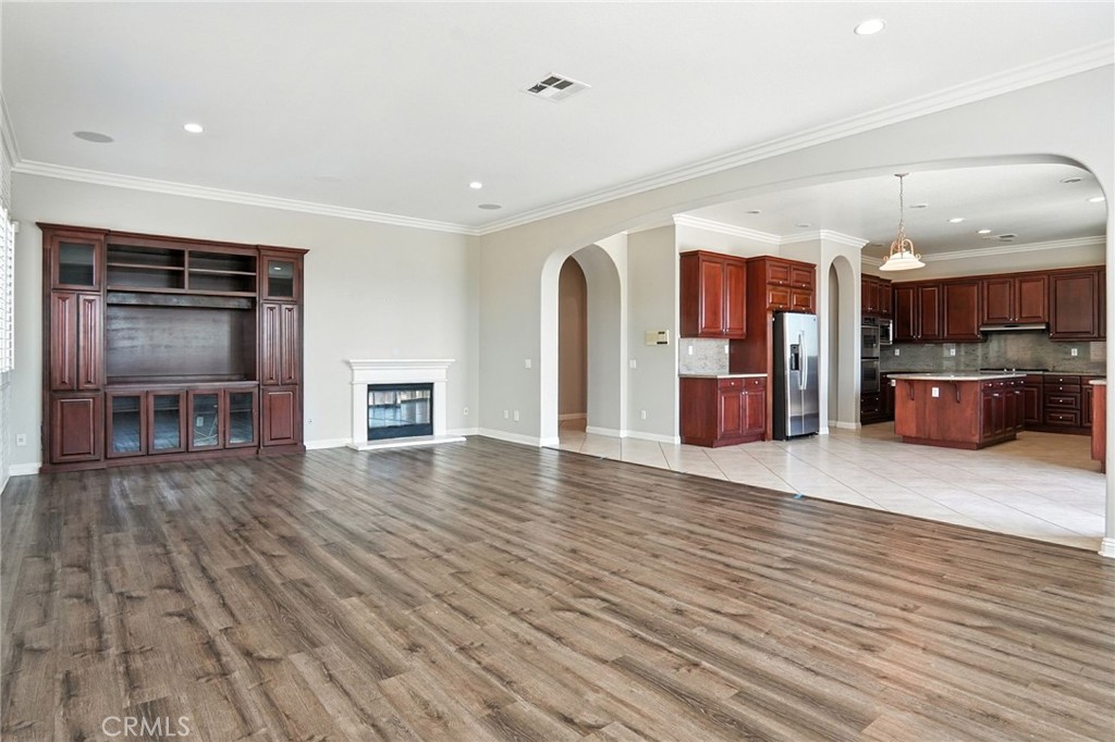 18338 Lakepointe Drive Riverside, CA 92503 - Photo 15 of 40 a view of a living room and kitchen with furniture and wooden floor
