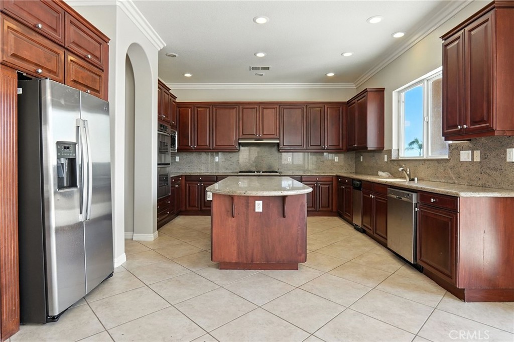 18338 Lakepointe Drive Riverside, CA 92503 - Photo 17 of 40 a large kitchen with stainless steel appliances granite countertop a stove a sink dishwasher a refrigerator and a oven