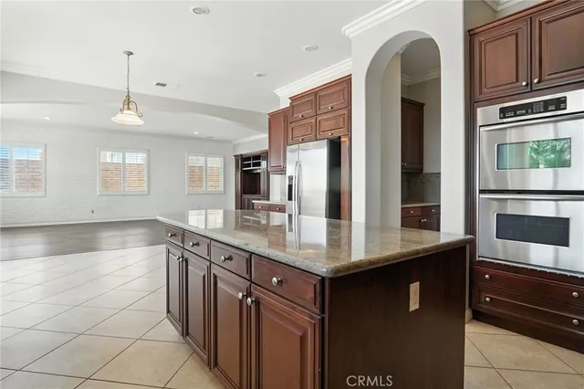 a kitchen with stainless steel appliances granite countertop a sink and cabinets