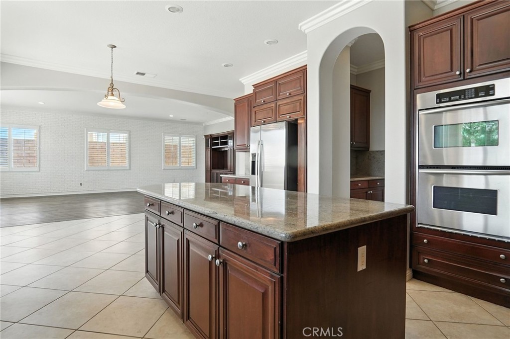 18338 Lakepointe Drive Riverside, CA 92503 - Photo 20 of 40 a kitchen with stainless steel appliances granite countertop a sink and cabinets