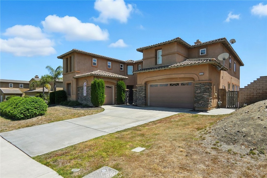 18338 Lakepointe Drive Riverside, CA 92503 - Photo 2 of 40 a front view of a house with a yard and garage