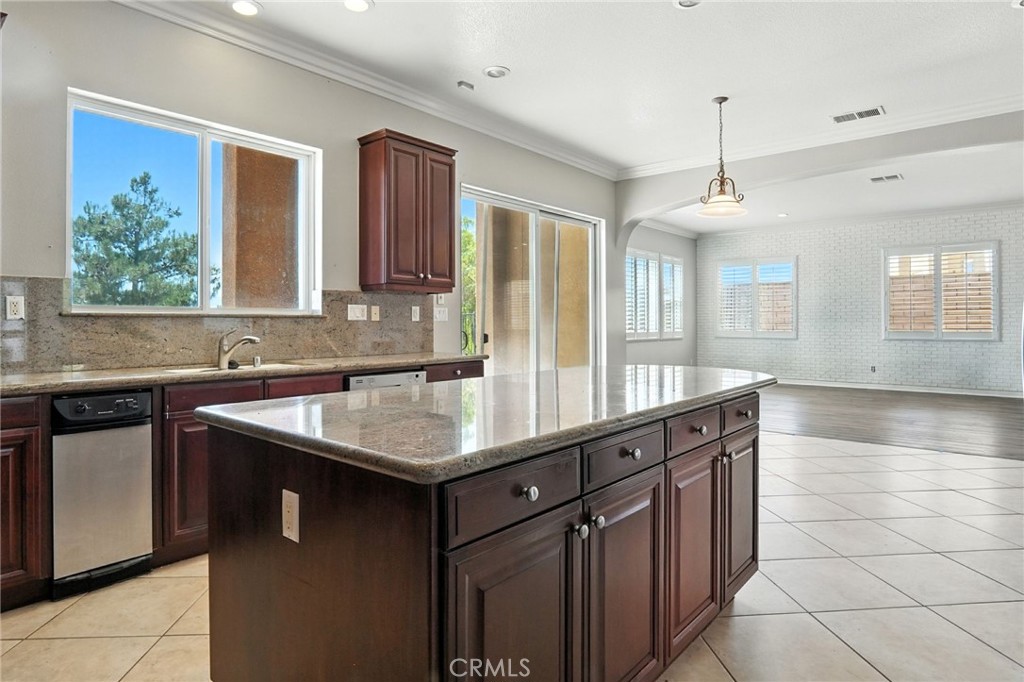 18338 Lakepointe Drive Riverside, CA 92503 - Photo 21 of 40 a kitchen with a sink stove and cabinets