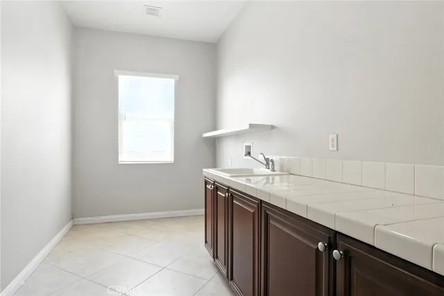 a kitchen with a sink cabinets and a window