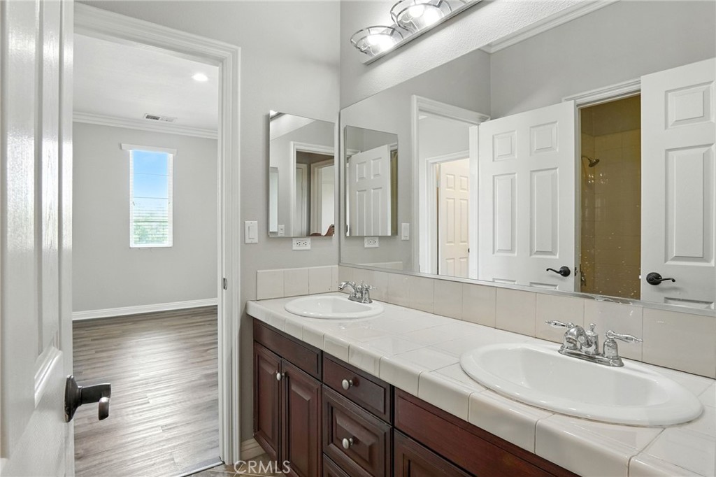 18338 Lakepointe Drive Riverside, CA 92503 - Photo 29 of 40 a bathroom with double vanity sinks and a mirror