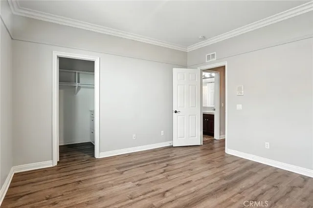 a view of an empty room with wooden floor