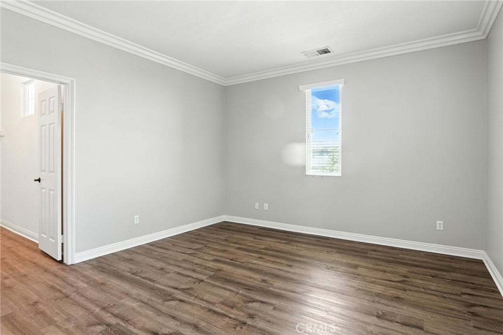 18338 Lakepointe Drive Riverside, CA 92503 - Photo 32 of 40 an empty room with wooden floor and windows