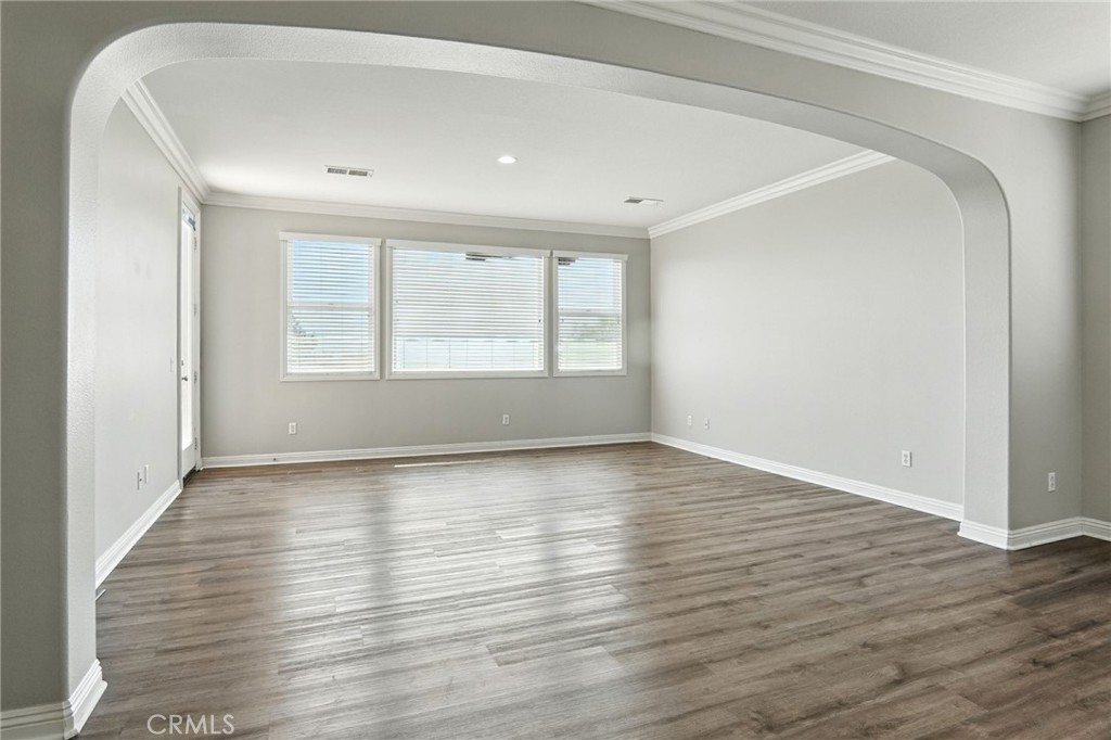 18338 Lakepointe Drive Riverside, CA 92503 - Photo 34 of 40 an empty room with wooden floor and window
