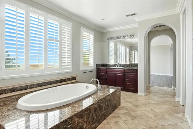 a spacious bathroom with a granite countertop tub and a sink