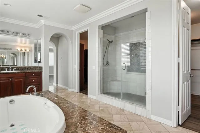 a bathroom with a tub sink and mirror