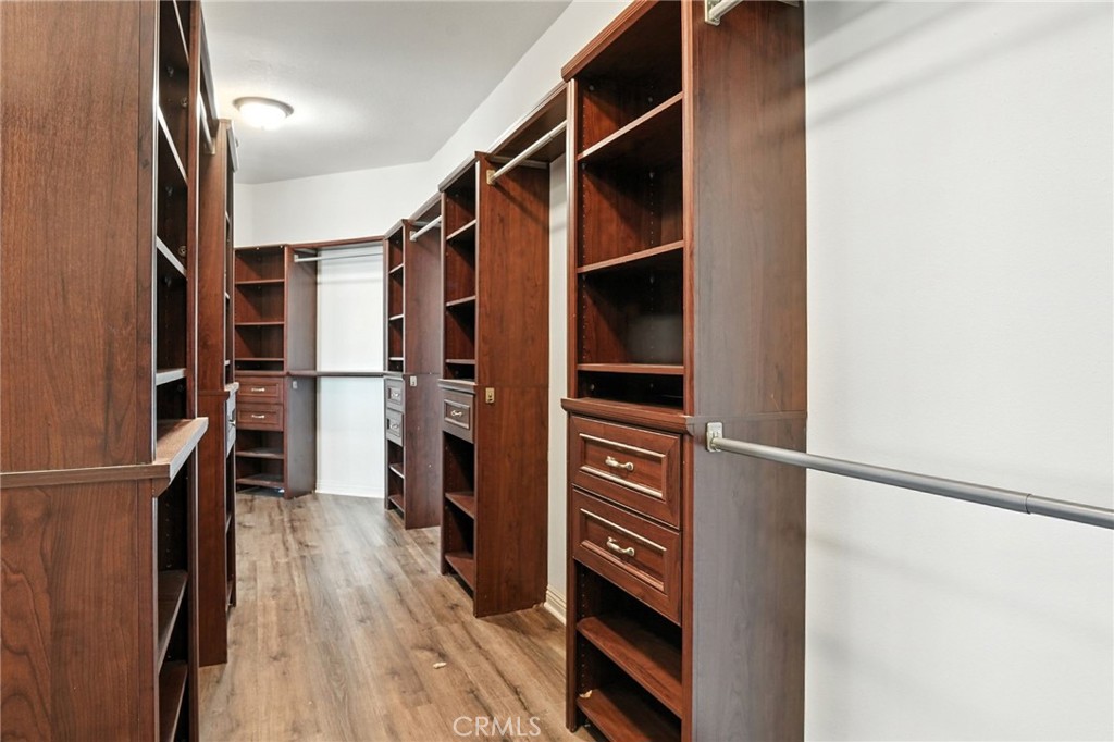 18338 Lakepointe Drive Riverside, CA 92503 - Photo 38 of 40 a view of walk in closet with clothes and shoes