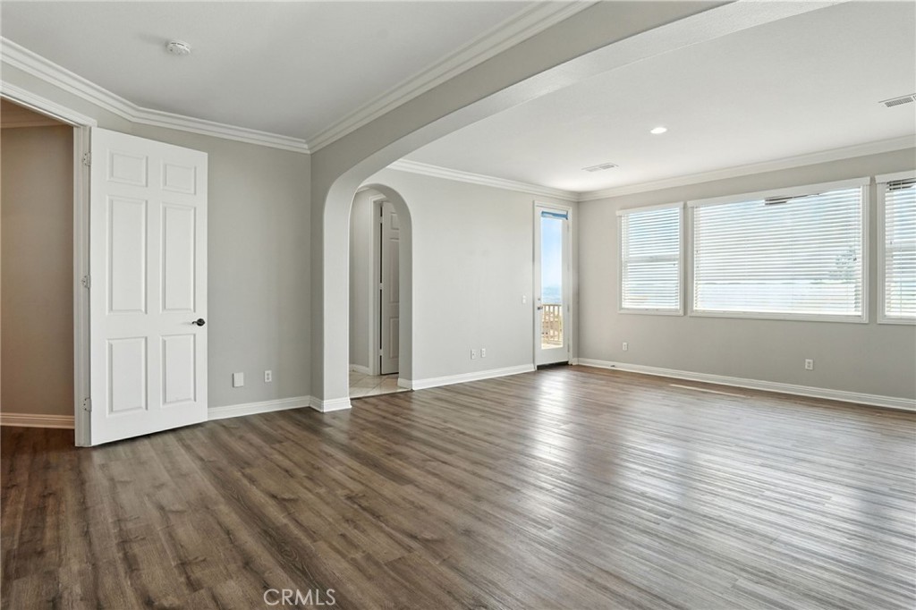 18338 Lakepointe Drive Riverside, CA 92503 - Photo 8 of 40 an empty room with wooden floor and windows